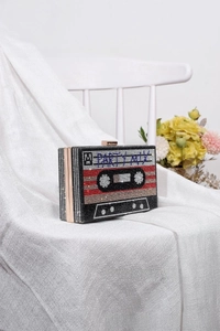 Detailed close-up of retro cassette tape clutch bag with hand-set sparkling rhinestones
