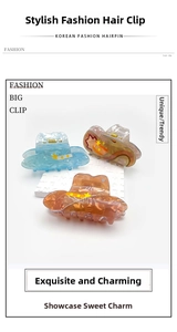 Detailed set of three large acrylic hair claws with star patterns in blue and amber