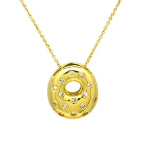 Macro shot of bubble letter pendant with sparkling zircons and fine gold chain
