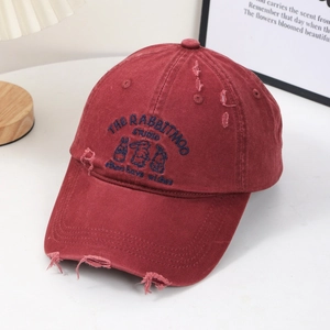 Detail of dark red distressed baseball cap with rabbit embroidery and ripped texture