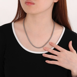 Close-up of classic polished silver popcorn chain necklace worn by model for jewelry detail
