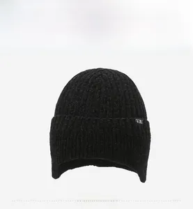 Detailed front view of black knit beanie featuring ear protection and Sport patch