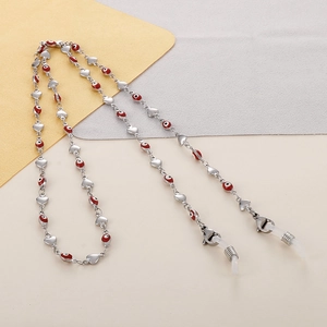 Detail of silver titanium heart chain with red evil eye charms and silicone loops