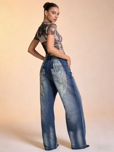 Detail der weißen Flügelstickerei auf der Gesäßtasche der gewaschenen blauen Jeans