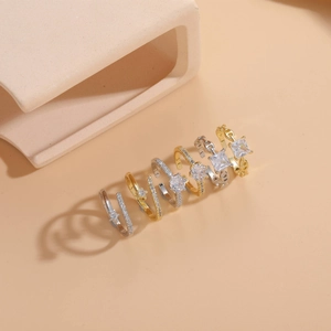 Macro shot of 6-piece zircon geometric ring set in gold and silver finish with star accents