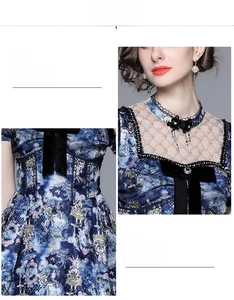 Detailed close-up of blue dress neckline with lace patchwork and black satin bow accent