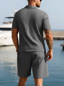 Rear view of men's grey polo and shorts set with waffle knit texture at a sunny harbor