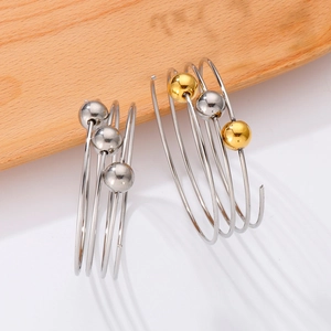 Detail of spiral multi-layer stainless steel bracelet with small metallic beads