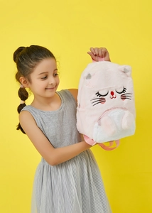 Detail of pink plush cat backpack for kids featuring soft faux fur and adjustable straps