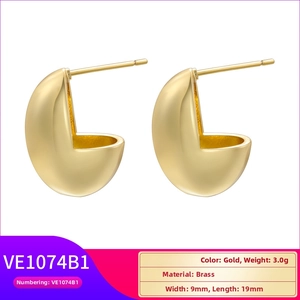 Macro detail of matte gold brass hoop earrings showing dimensions 19mm by 9mm