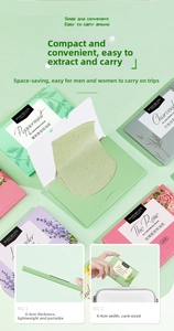Close-up of portable oil absorbing facial paper boxes showing 9.4cm size and 100 sheets