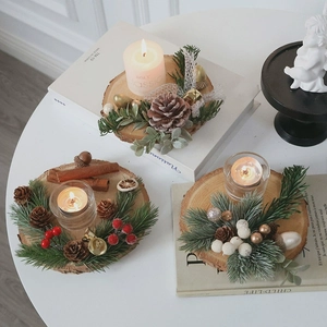 Three Christmas wooden candle holders with pine cones, berries, and golden bells