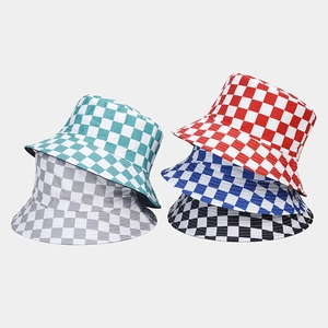 Detail view of double-sided bucket hats with plaid checkerboard patterns in five colors