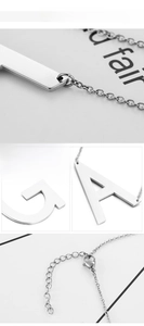 Macro detail of alphabet pendants A and J with adjustable lobster clasp and steel chain
