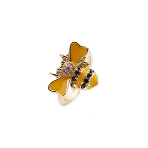 Detailed view of 18K gold plated bee ring with yellow enamel wings and white zircon inlay