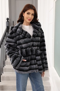 Detail of grey striped faux fur coat with belted waist styled with denim jeans