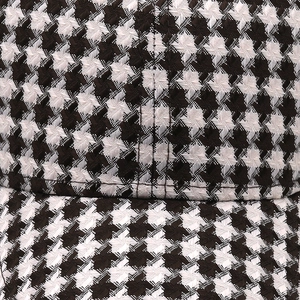 Macro shot of houndstooth knit texture and precision stitching on the baseball cap