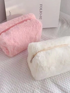 Plush macaron colored makeup bags in pink and beige with soft faux fur and zip closure