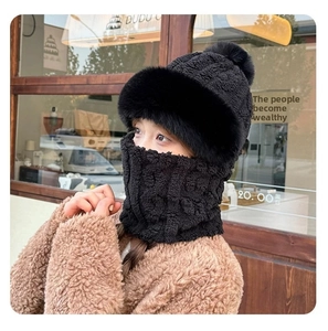 Detail of black winter knit trapper hat with fur trim and matching neck warmer set