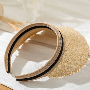 Detail of hand-woven straw sun visor with black stripe accent and headband structure