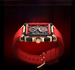 Detail of square hollow quartz watch with red silicone strap and gold-black case