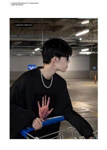 7mm wide silver Cuban chain necklace on male model wearing a black palm graphic sweatshirt