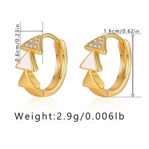 Detail of vintage gold earrings with white enamel triangle design and zircon stones