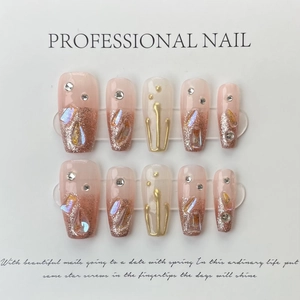 Handmade gradient press-on nails with luxury rhinestones and silver glitter in nude pink