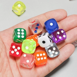 Colorful mix of transparent and solid resin dice held in palm for board games