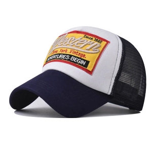 Detail of 3D Western embroidery on retro blue mesh trucker hat with vintage patch