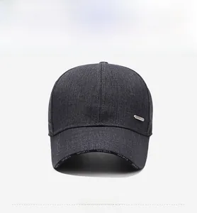 Detail of dark grey winter baseball cap showing SPORTS text on visor and metal logo