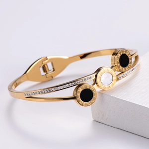 Gold plated stainless steel bangle with roman numerals, shell inlay and crystals