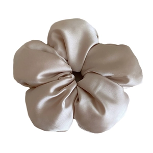 Elegant champagne satin flower scrunchie with a silky finish and soft floral petal design