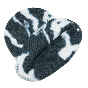 Detail shot of tie-dye knit beanie showing navy and white textured patterns and thick yarn