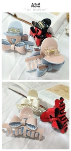 Detailed close-up of bow-shaped acetate hair claw clips with hollow-out lace design