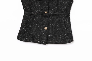 Detail of black tweed vest with gold woven buttons and subtle sequin embellishments