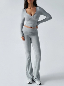 Detail of grey V-neck knit long sleeve top with twist knot and matching flare pants