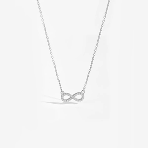 Detailed view of the silver infinity pendant featuring pave-set white cubic zirconia stones