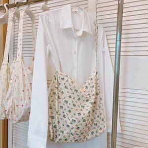 Close-up of the small floral pattern and fabric texture on a cotton canvas tote bag