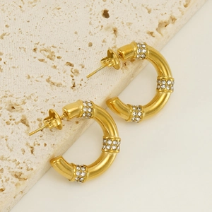 Gold stainless steel C-shaped earrings featuring bamboo segments and sparkling crystals