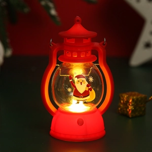 Close-up of red vintage Christmas lantern with Santa Claus pattern and warm LED light