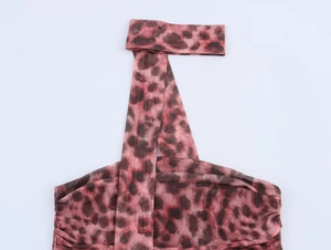 Detailed macro view of leopard print mesh fabric with drawstring neck and ruching detail