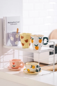 White metal double-tier rack with hand-painted ceramic coffee cups and saucer sets