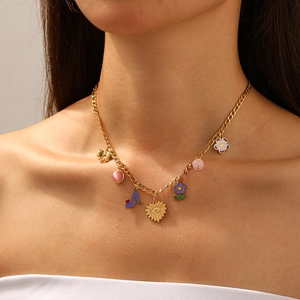 Gold-plated necklace with colorful flower, bow, and high heel charms on a female model