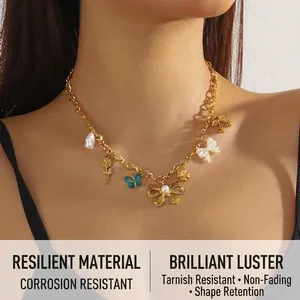 Close-up of gold chain necklace featuring blue butterfly and pearl bow charms on a model