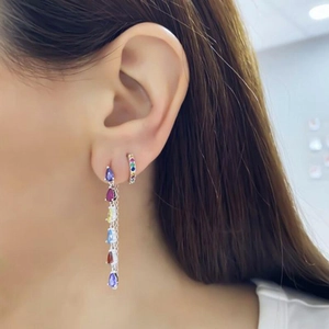 Detail view of s925 silver needle earrings with colorful tassel zircons on a model