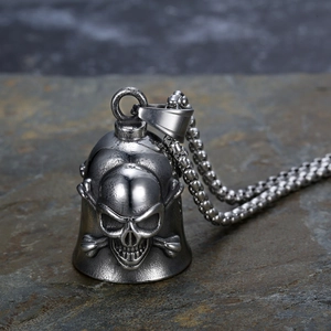 Vintage stainless steel skull guardian bell pendant with beaded chain on stone surface