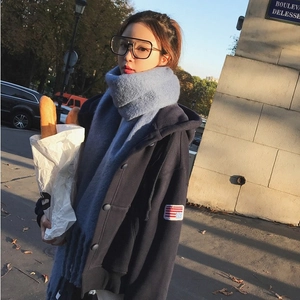 Thick light blue mohair scarf and navy hoodie styled in a warm winter street look