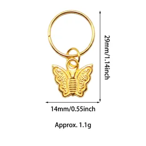 Detail view of a gold alloy butterfly pendant charm for hair braid accessories
