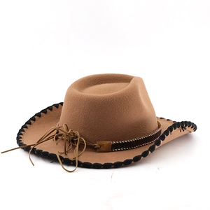 Detail of tan felt cowboy hat with black whipstitched brim and brown decorative leather band